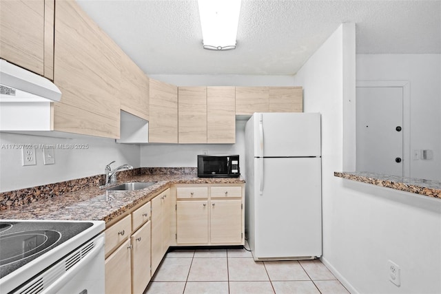 kitchen featuring sink, stone countertops, a textured ceiling, light tile patterned floors, and white appliances