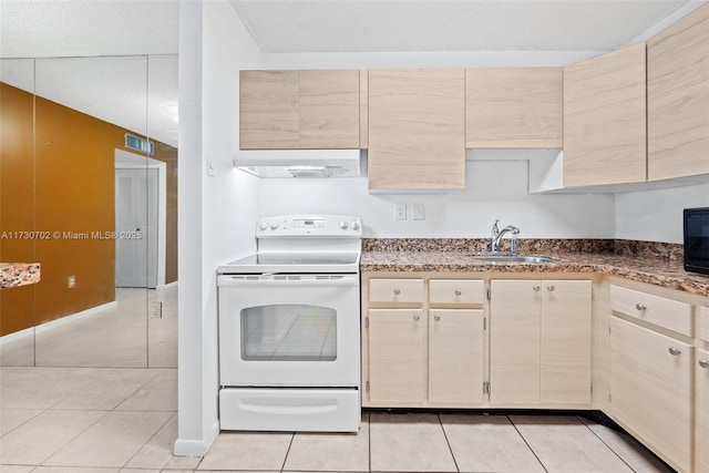 kitchen featuring light tile patterned flooring, white range with electric cooktop, light brown cabinetry, and sink