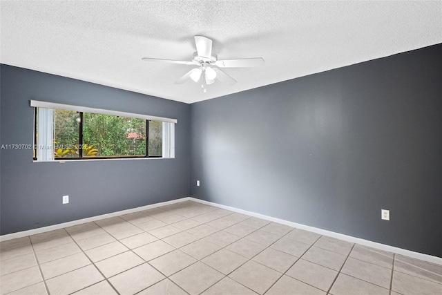 tiled empty room featuring a textured ceiling and ceiling fan