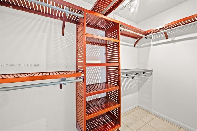 spacious closet featuring tile patterned floors