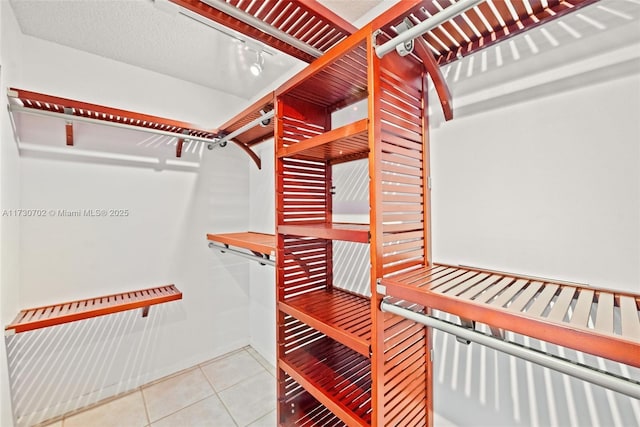 walk in closet with tile patterned flooring