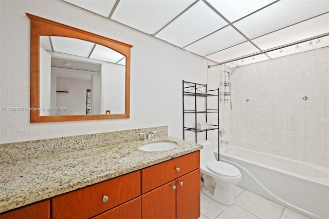 full bathroom featuring tile patterned floors, vanity, toilet, and tiled shower / bath combo