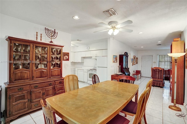 tiled dining area featuring ceiling fan