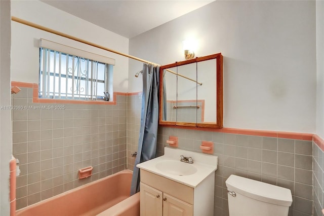 full bathroom featuring vanity, toilet, and shower / bath combo with shower curtain