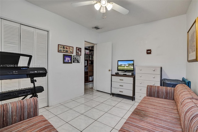 tiled living room featuring ceiling fan