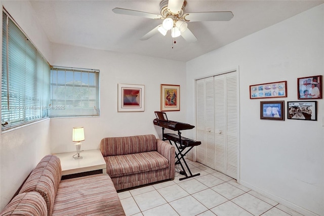 living area with light tile patterned flooring and ceiling fan