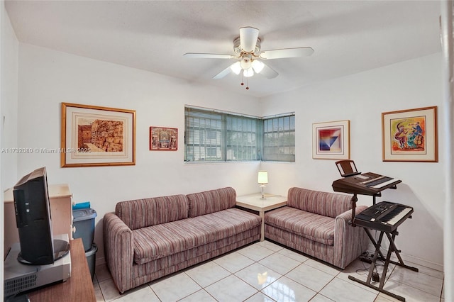 living room with a textured ceiling, ceiling fan, and light tile patterned flooring