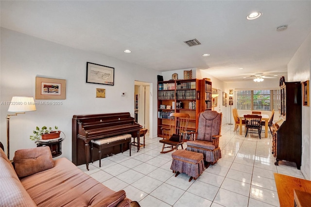 tiled living room featuring ceiling fan