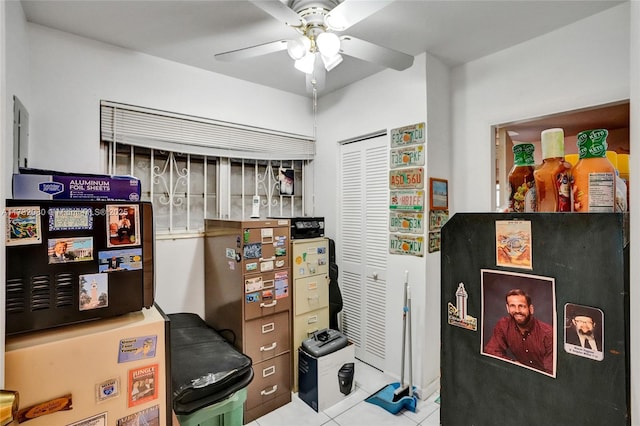 tiled office space featuring ceiling fan