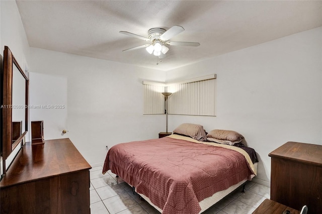 tiled bedroom featuring ceiling fan