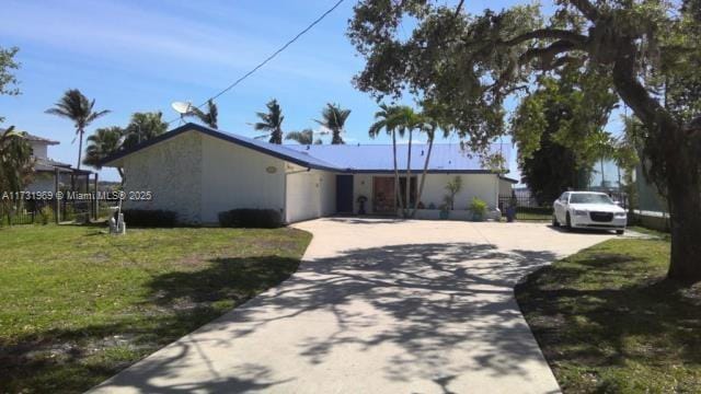 ranch-style home with a front lawn