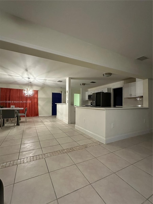 interior space featuring white cabinetry, light tile patterned flooring, kitchen peninsula, and black refrigerator with ice dispenser