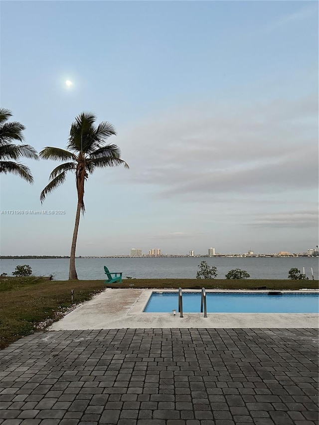 view of pool with a water view