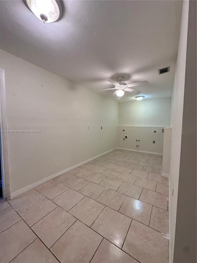 spare room featuring light tile patterned floors and ceiling fan