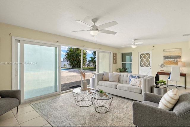 living room featuring light tile patterned floors and a ceiling fan