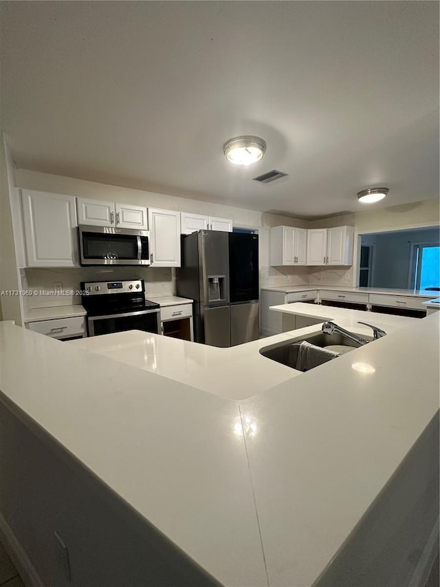 kitchen featuring white cabinetry, appliances with stainless steel finishes, and sink