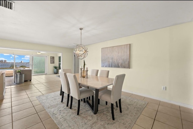 dining area with visible vents, a notable chandelier, baseboards, and light tile patterned floors