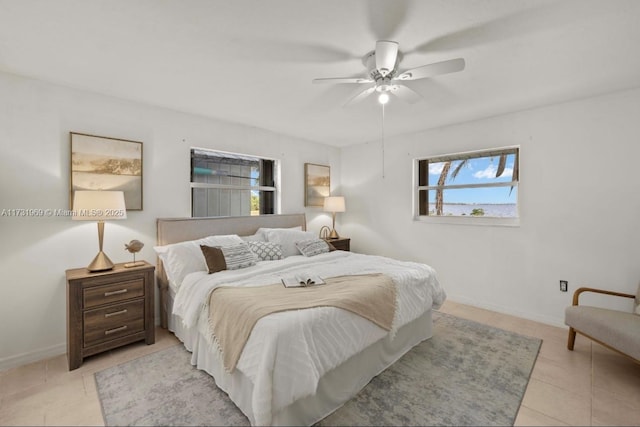 bedroom featuring light tile patterned floors, ceiling fan, and baseboards