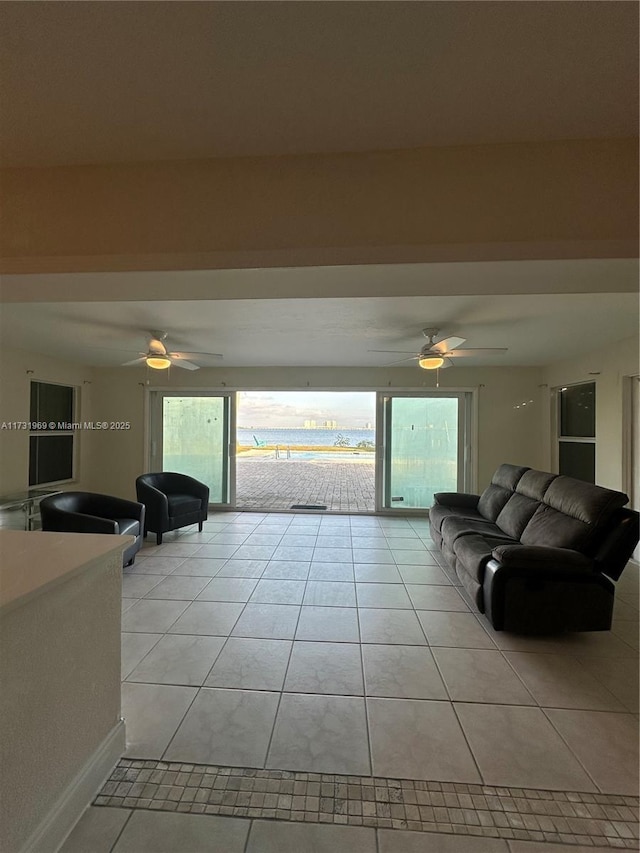 tiled living room featuring ceiling fan