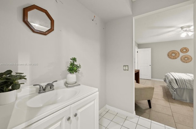 bathroom featuring tile patterned flooring, ceiling fan, vanity, and baseboards