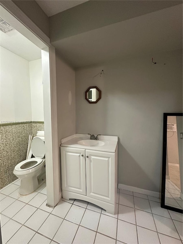 bathroom with vanity, tile patterned floors, and toilet