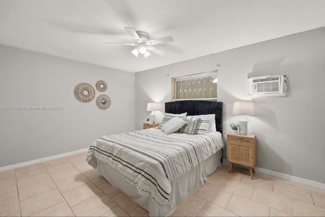 bedroom with an AC wall unit, baseboards, and light tile patterned floors