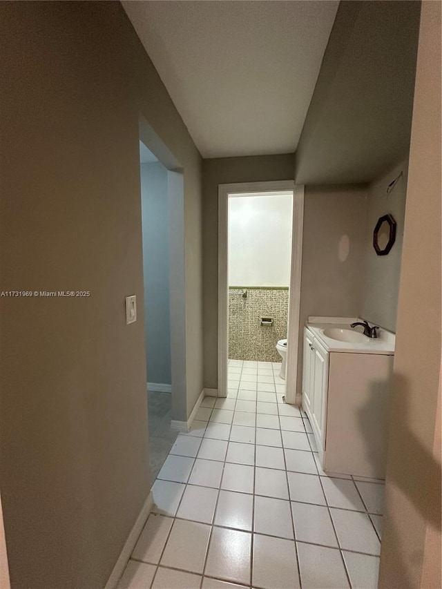 bathroom featuring vanity, toilet, and tile patterned flooring