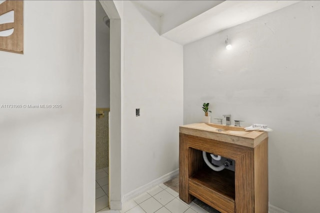 bathroom featuring tile patterned flooring, vanity, and baseboards