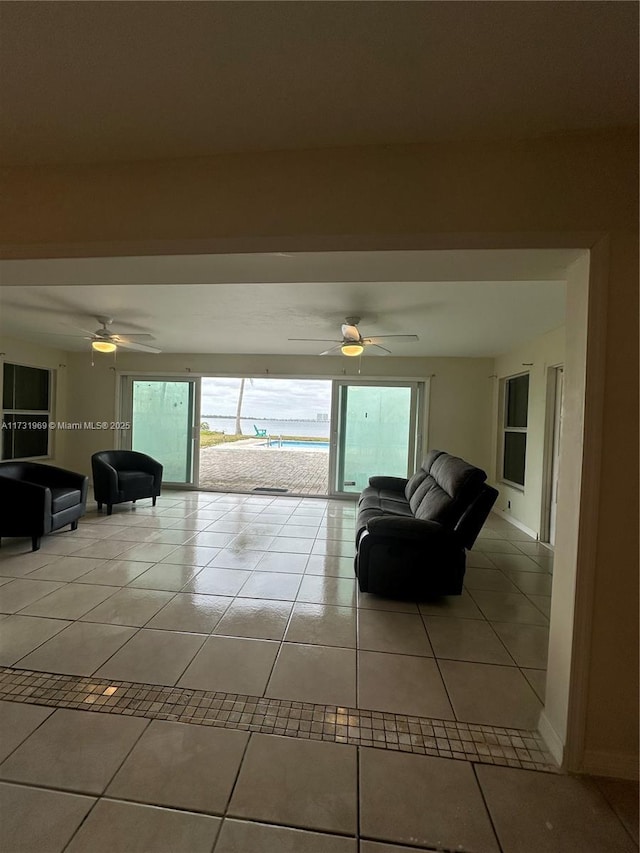 living room with light tile patterned floors and ceiling fan