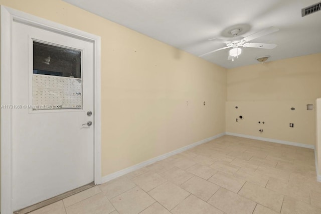 spare room featuring a ceiling fan, visible vents, baseboards, and light tile patterned flooring