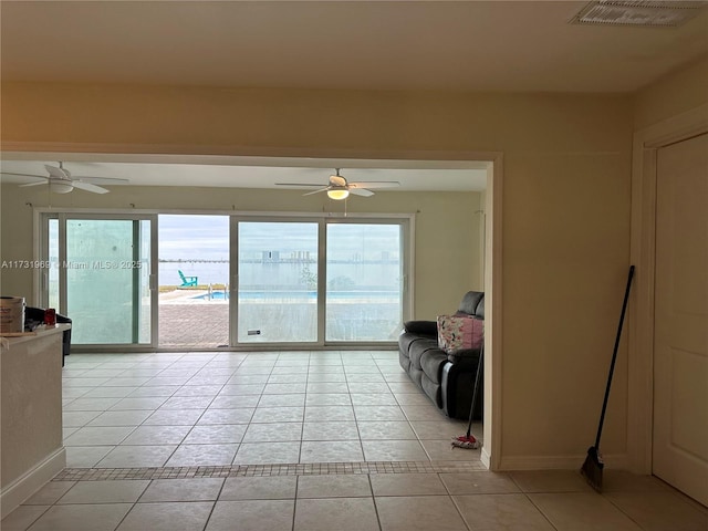 unfurnished living room with ceiling fan and light tile patterned floors