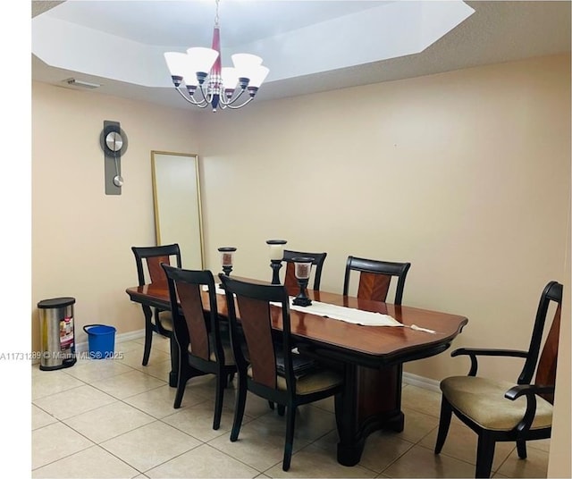 tiled dining area featuring an inviting chandelier