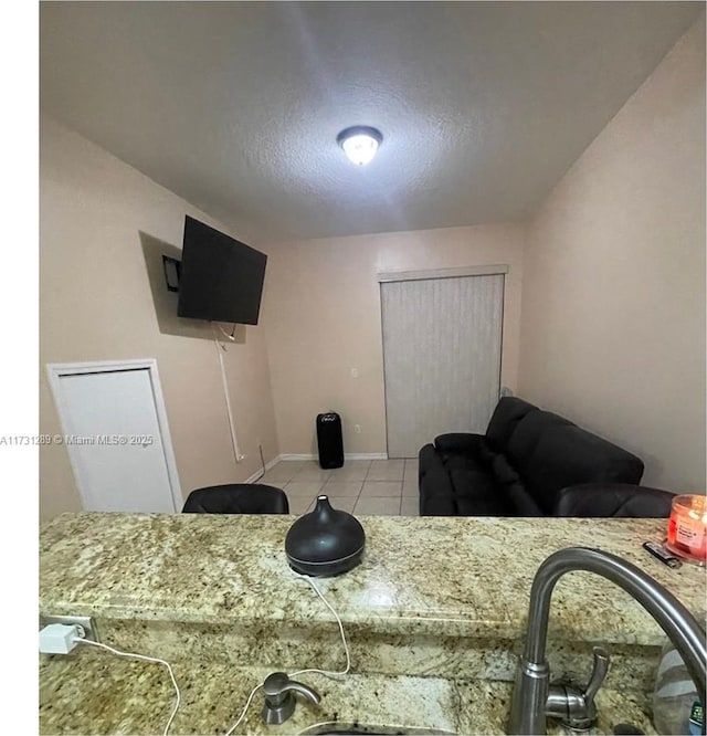 bedroom featuring sink and light tile patterned floors