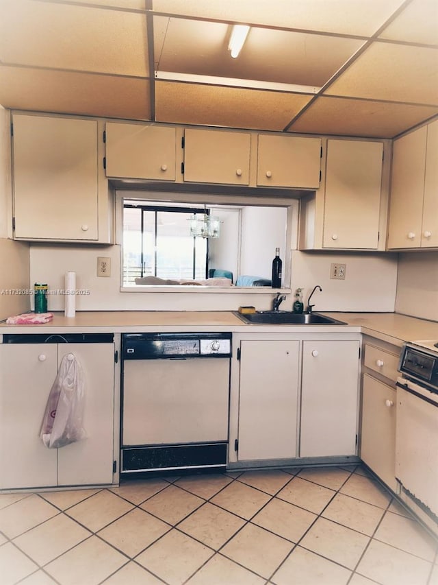 kitchen with dishwasher, sink, and light tile patterned flooring