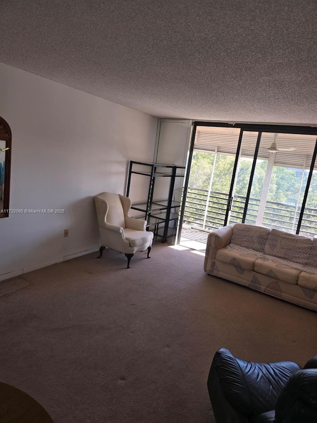 living room featuring expansive windows, carpet, and a textured ceiling