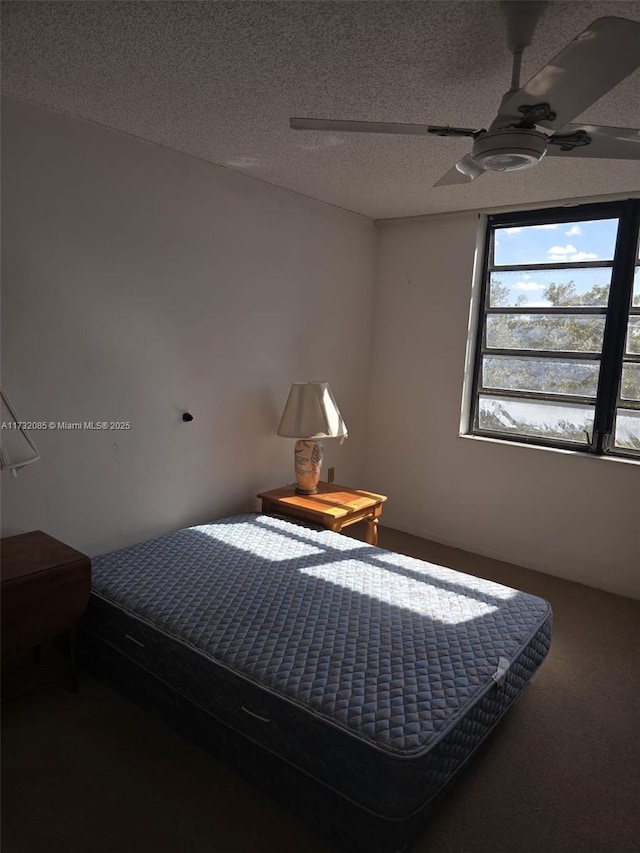 bedroom featuring a textured ceiling and ceiling fan