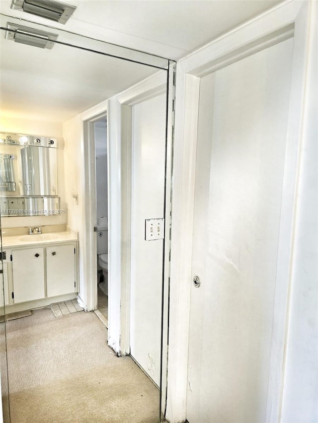 interior space with vanity and toilet