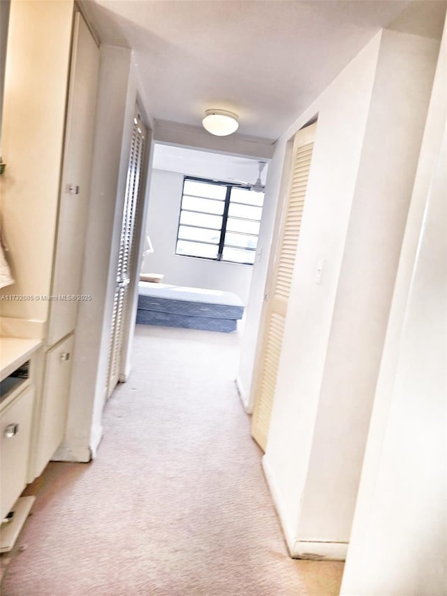 corridor with light colored carpet