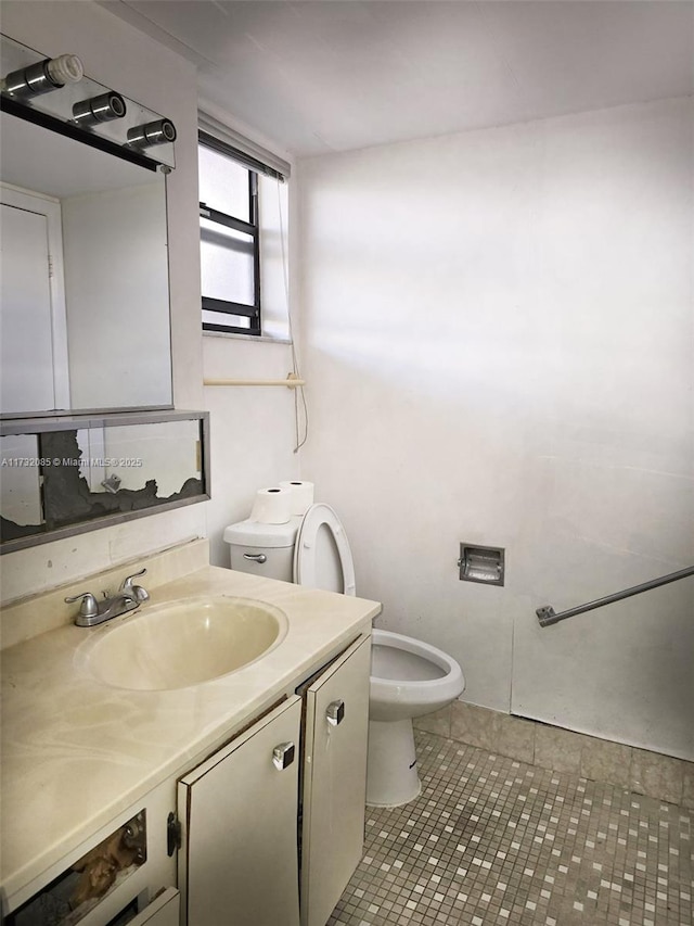 bathroom with vanity, toilet, and tile patterned flooring