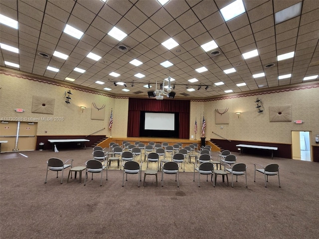 miscellaneous room with a paneled ceiling and carpet floors