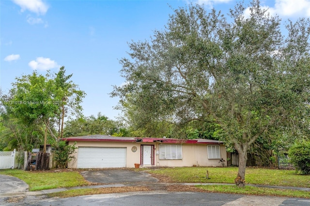 view of front facade with a garage and a front lawn