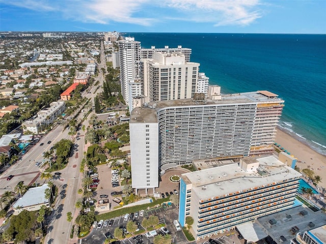 drone / aerial view with a water view and a beach view