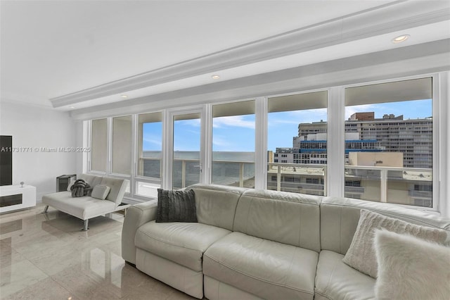 living room with crown molding and a water view