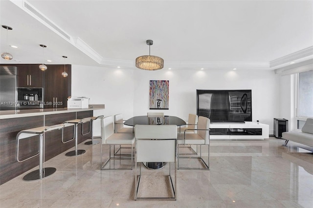 dining space featuring crown molding and a tray ceiling