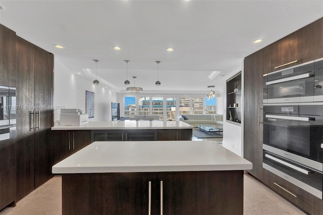 kitchen featuring pendant lighting, light tile patterned floors, built in shelves, and a kitchen island