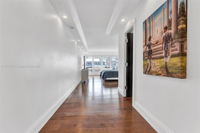 corridor with ornamental molding and dark hardwood / wood-style floors