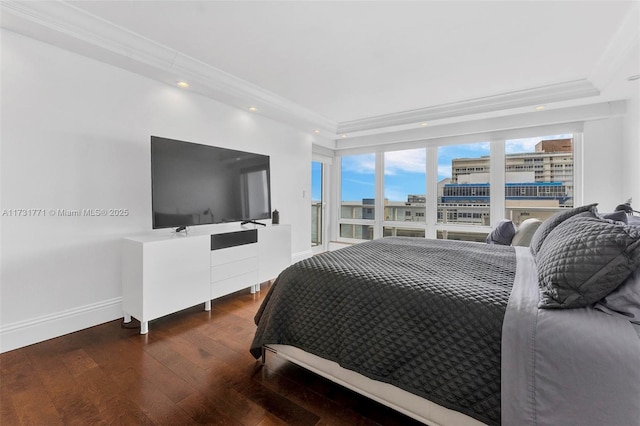 bedroom with ornamental molding and dark hardwood / wood-style flooring