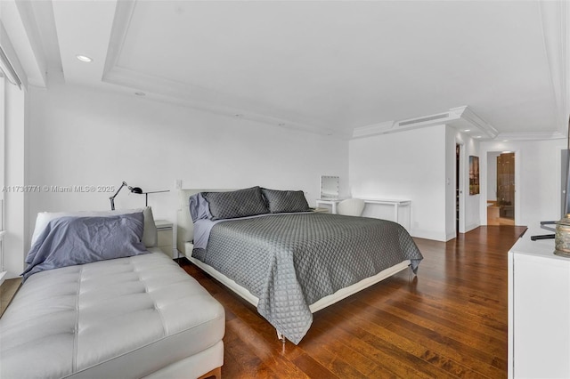 bedroom featuring dark hardwood / wood-style flooring and a tray ceiling