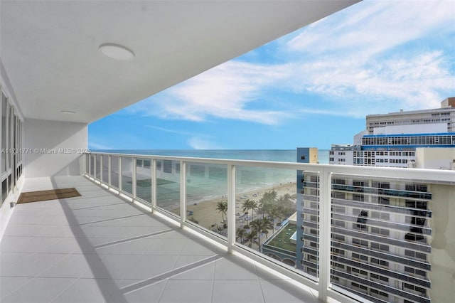 balcony featuring a water view and a beach view