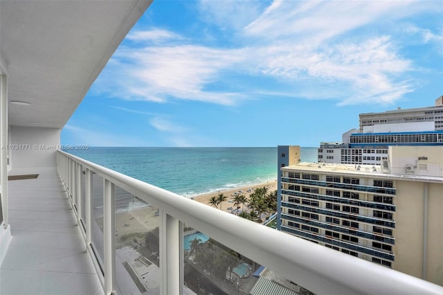 balcony with a water view and a beach view